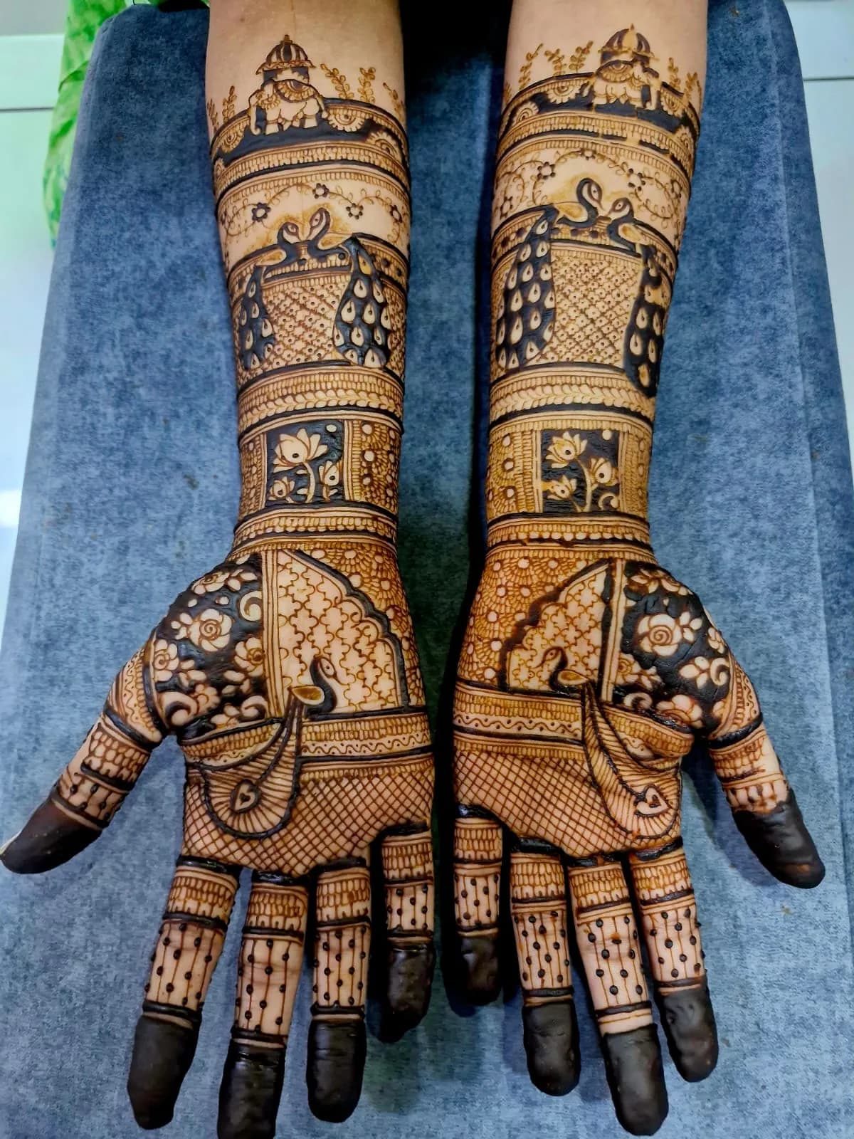 Bridal peacock and lotus mhendi on palms and forearms in Vastral Ahmedabad