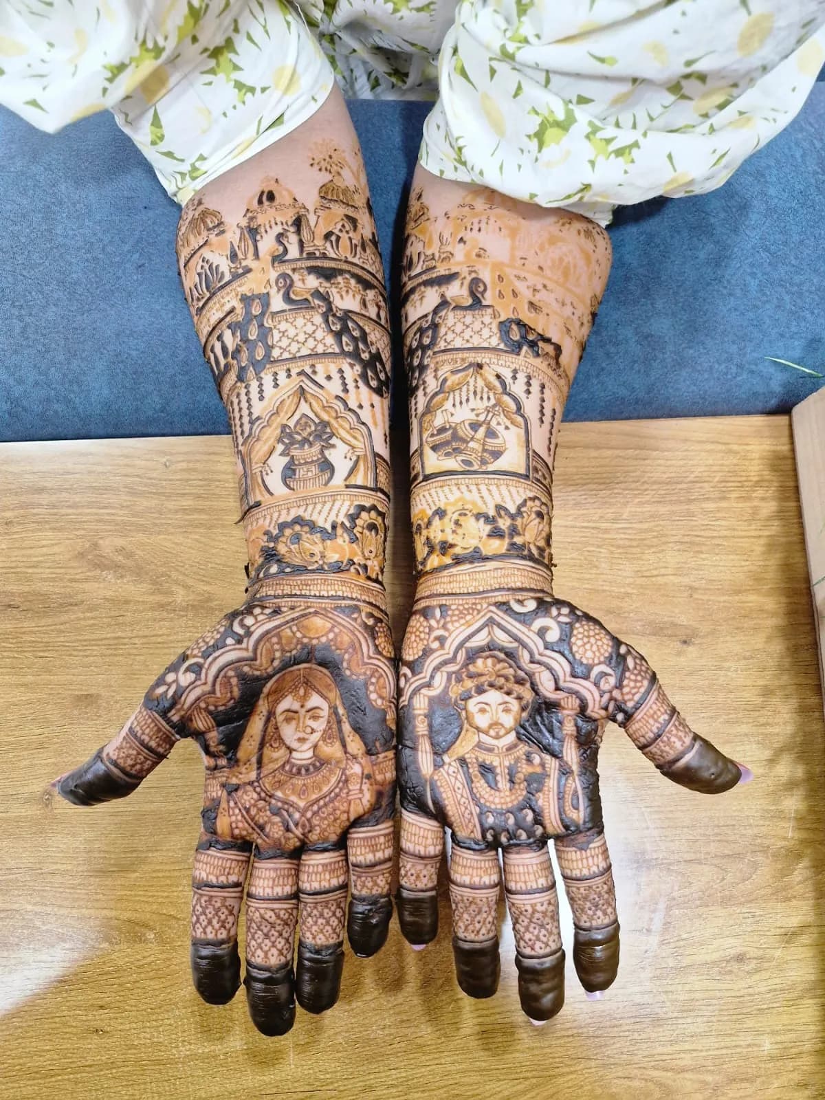 Bridal mhendi with bride and groom portrait figures on palms, Ahmedabad