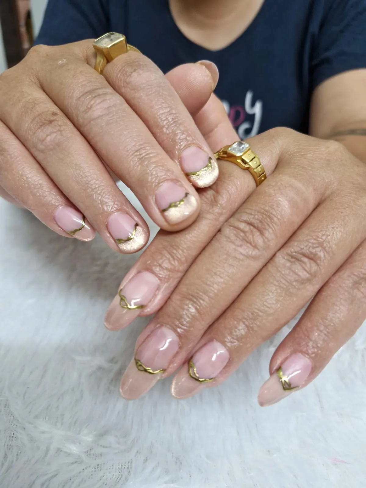 Nude nails with metallic gold V-tip French manicure in Ahmedabad
